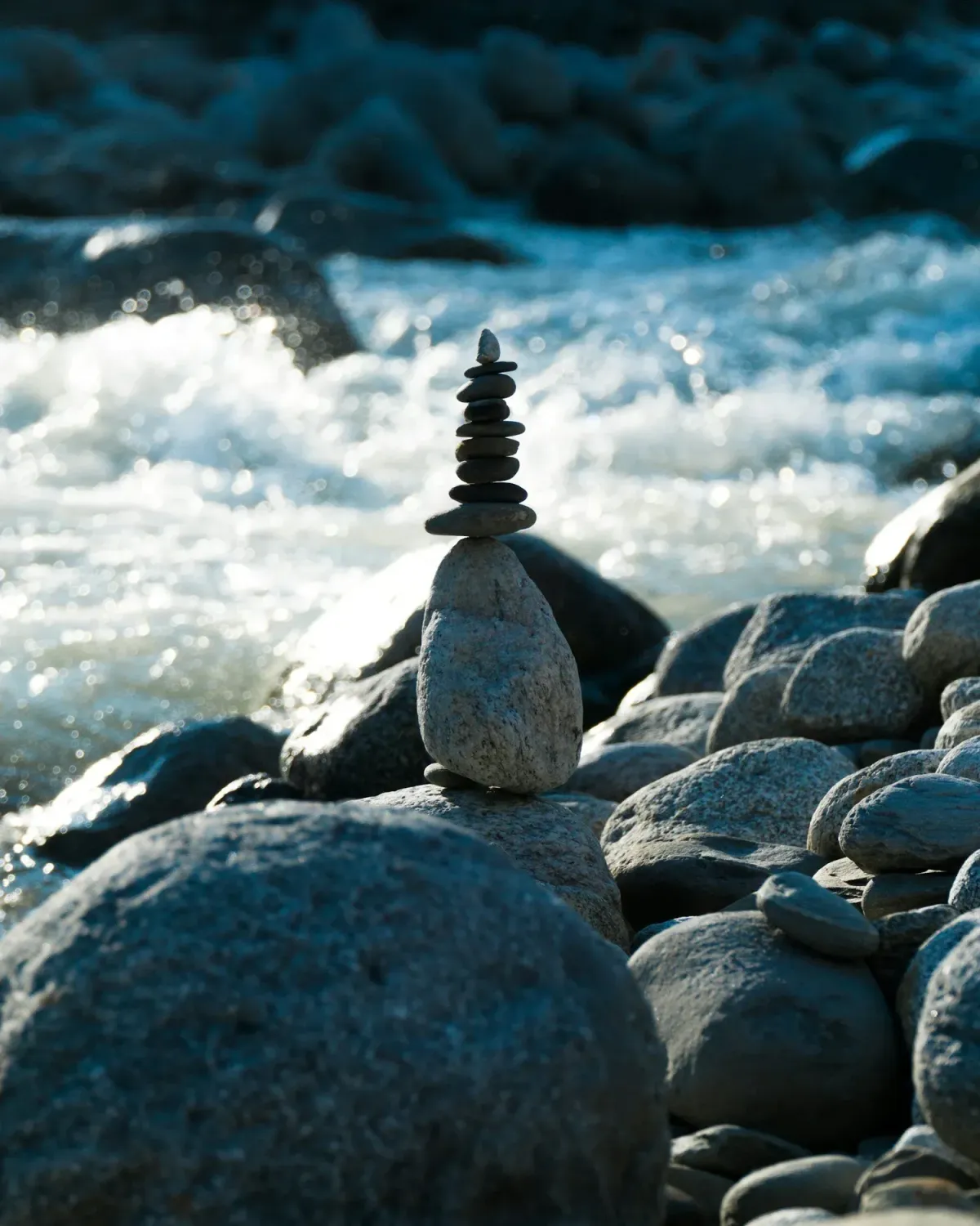 Balanced stone tower in nature, symbolizing calm, balance, and nervous system regulation for neurodivergent well-being.