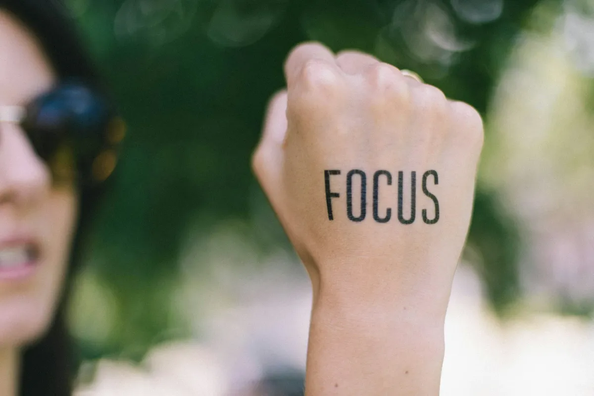 Handwritten word "focus" in bold lettering, emphasizing concentration and attention.