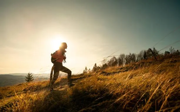 woman walking up a hill