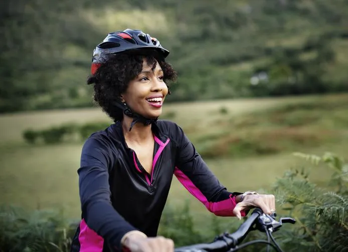 Black woman on bike with helmut