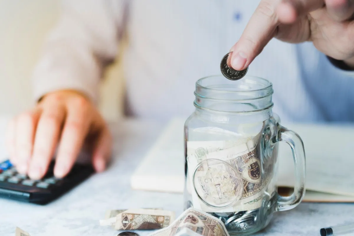 Person saving money slowly, showing the cost of time delay