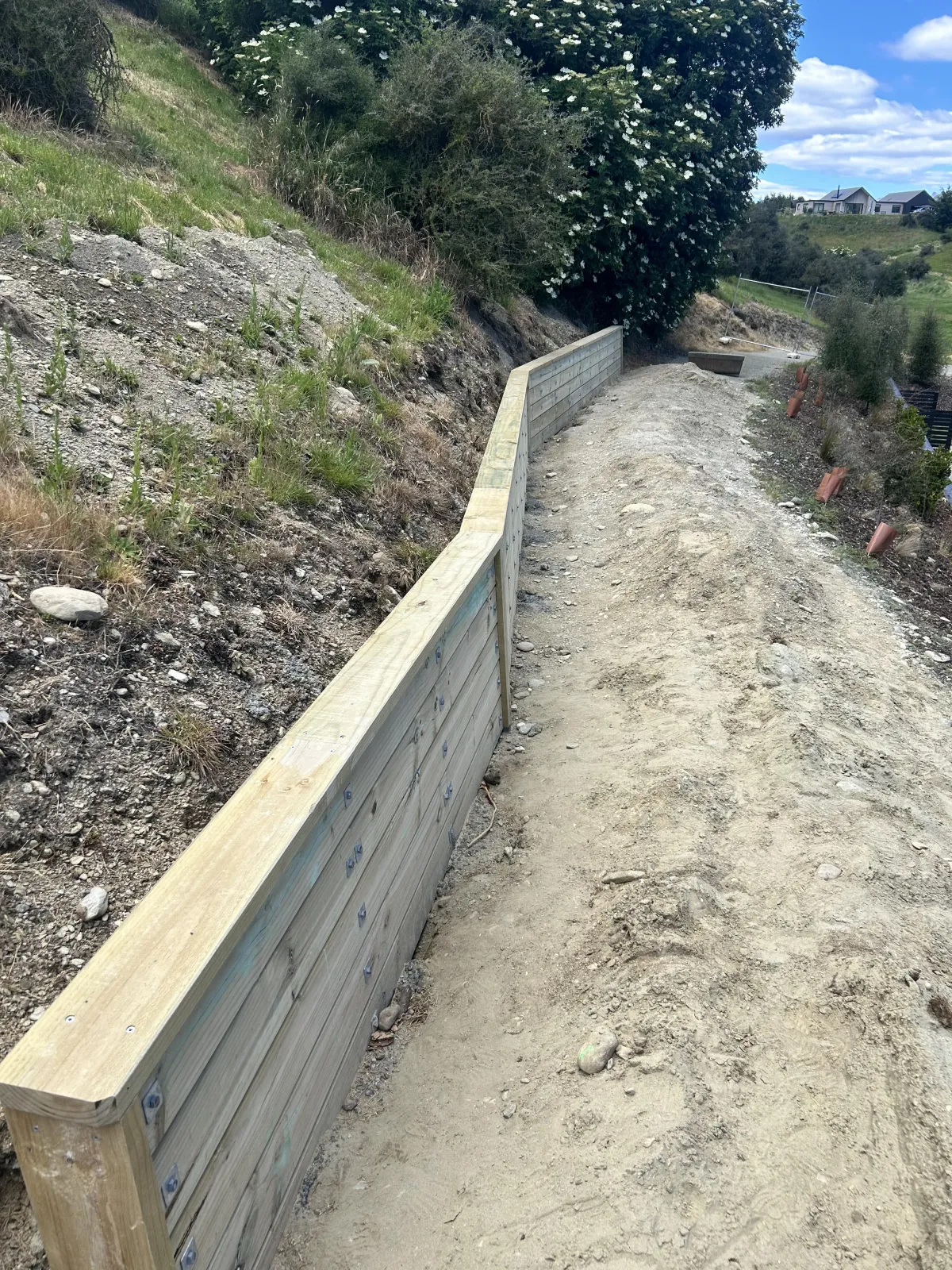 Concrete block retaining wall under construction along a driveway by G A Building