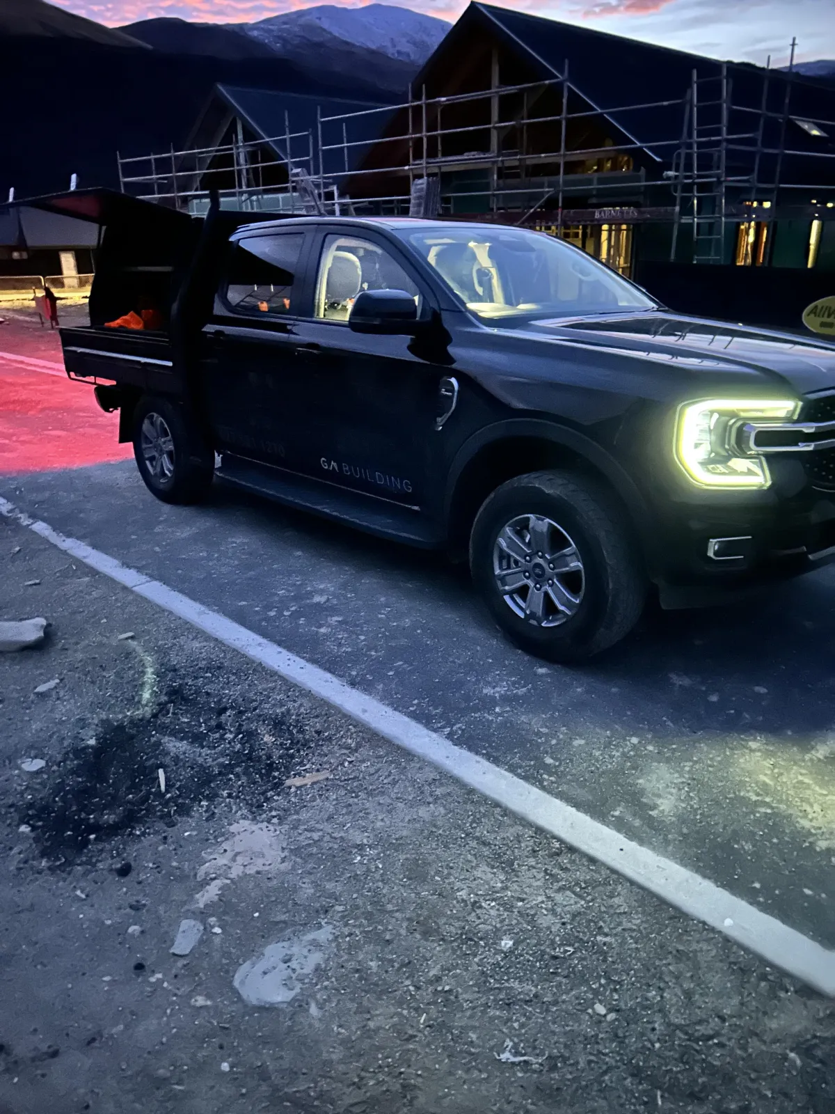 G A Building’s branded black truck parked on-site, reflecting professional construction services