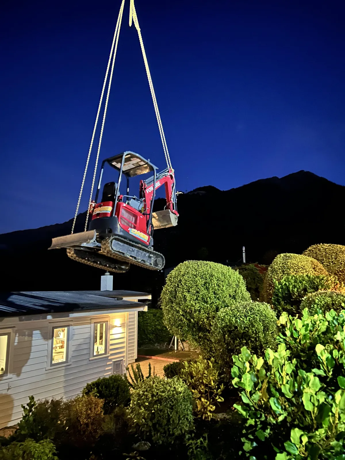 Crane hoisting materials at a Queenstown construction site managed by G A Building