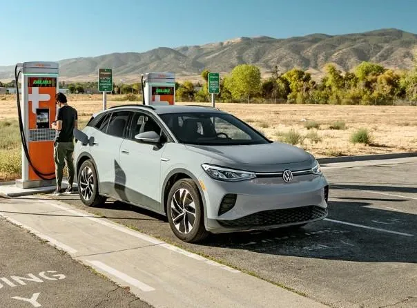 Chevy Bolt EV parked at a roadside charging station during a long-distance road trip.