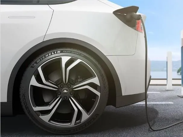 Close-up of an EV tire being inspected, representing the discussion around tire longevity for electric vehicles.