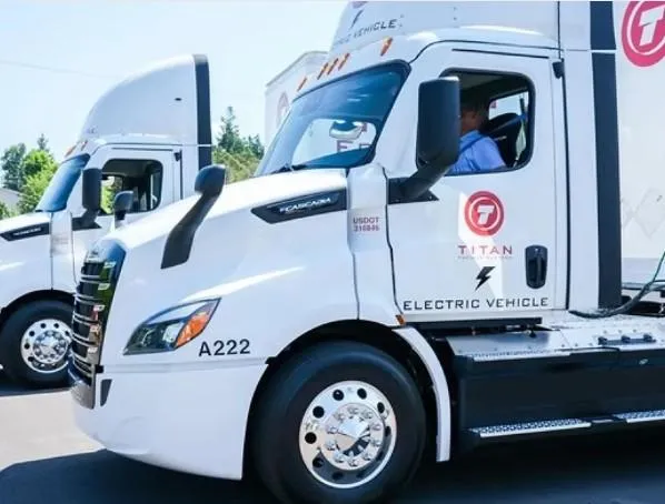Titan Freight Systems electric truck charging at a depot equipped with a smart energy management system.
