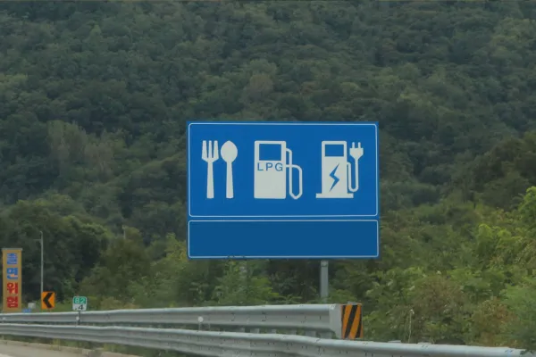 road sign indicating EV charging area