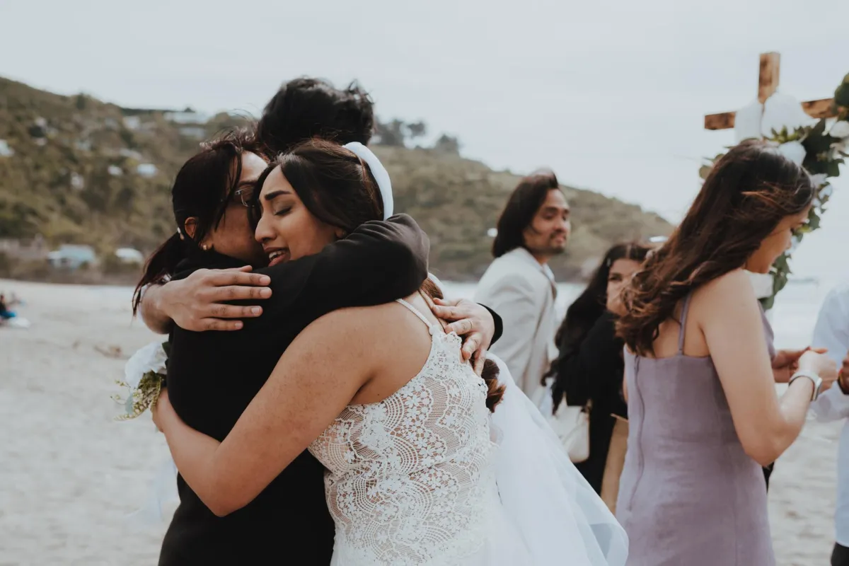 Bride hugging her mother crying