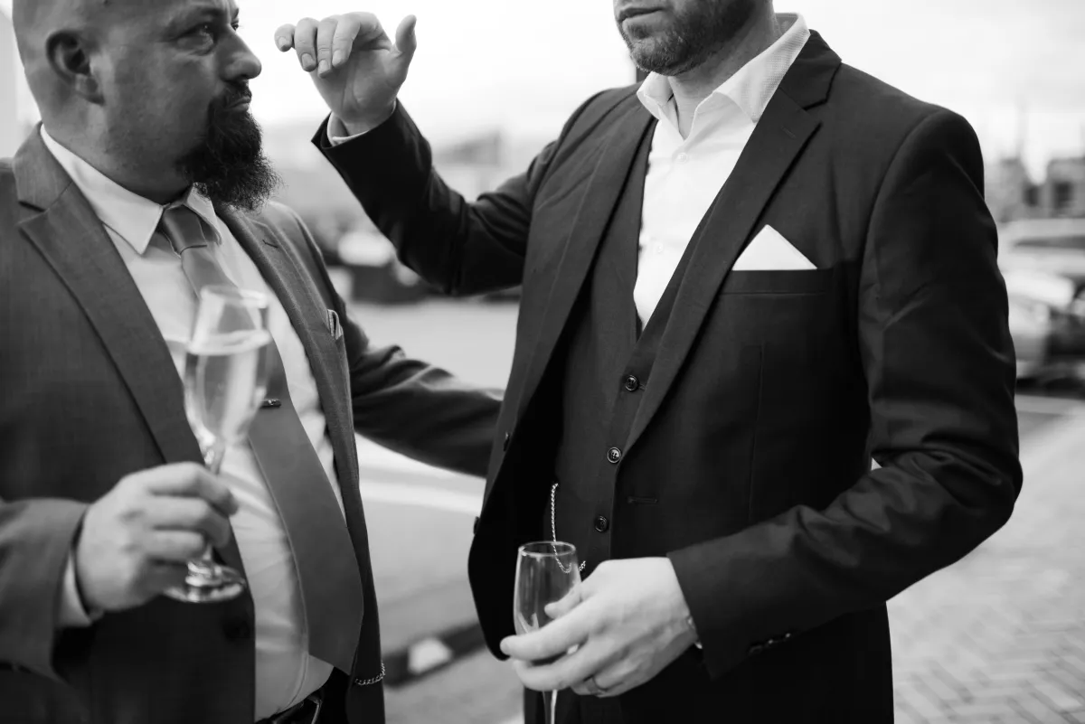 Grooms-person congratulating the newlyweds