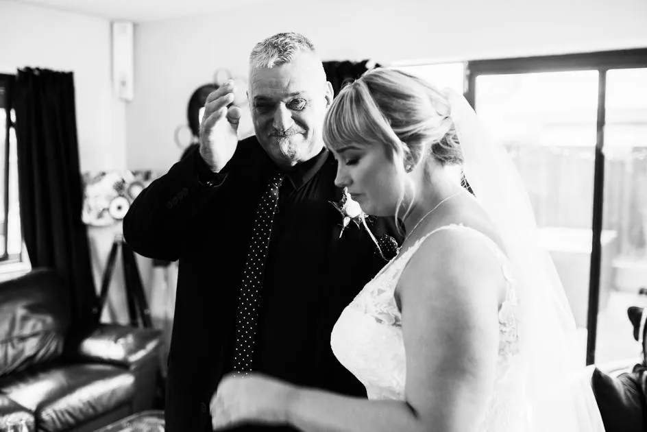 Father crying at first look with his daughter before her wedding