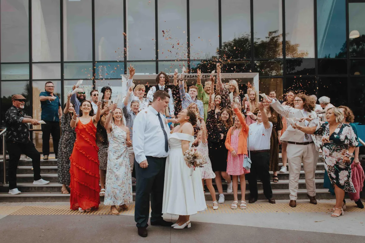 newlyweds showered in petals by their friends