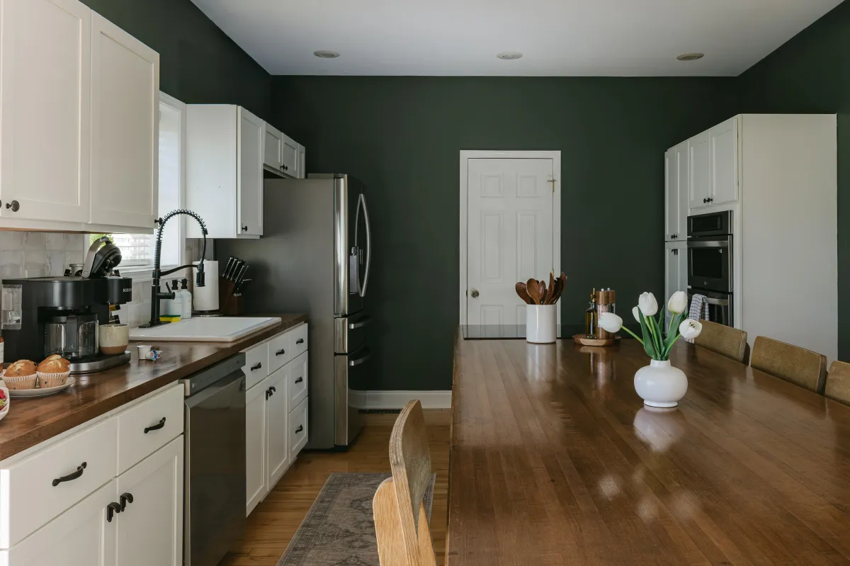 Large kitchen with island seating and access to deck