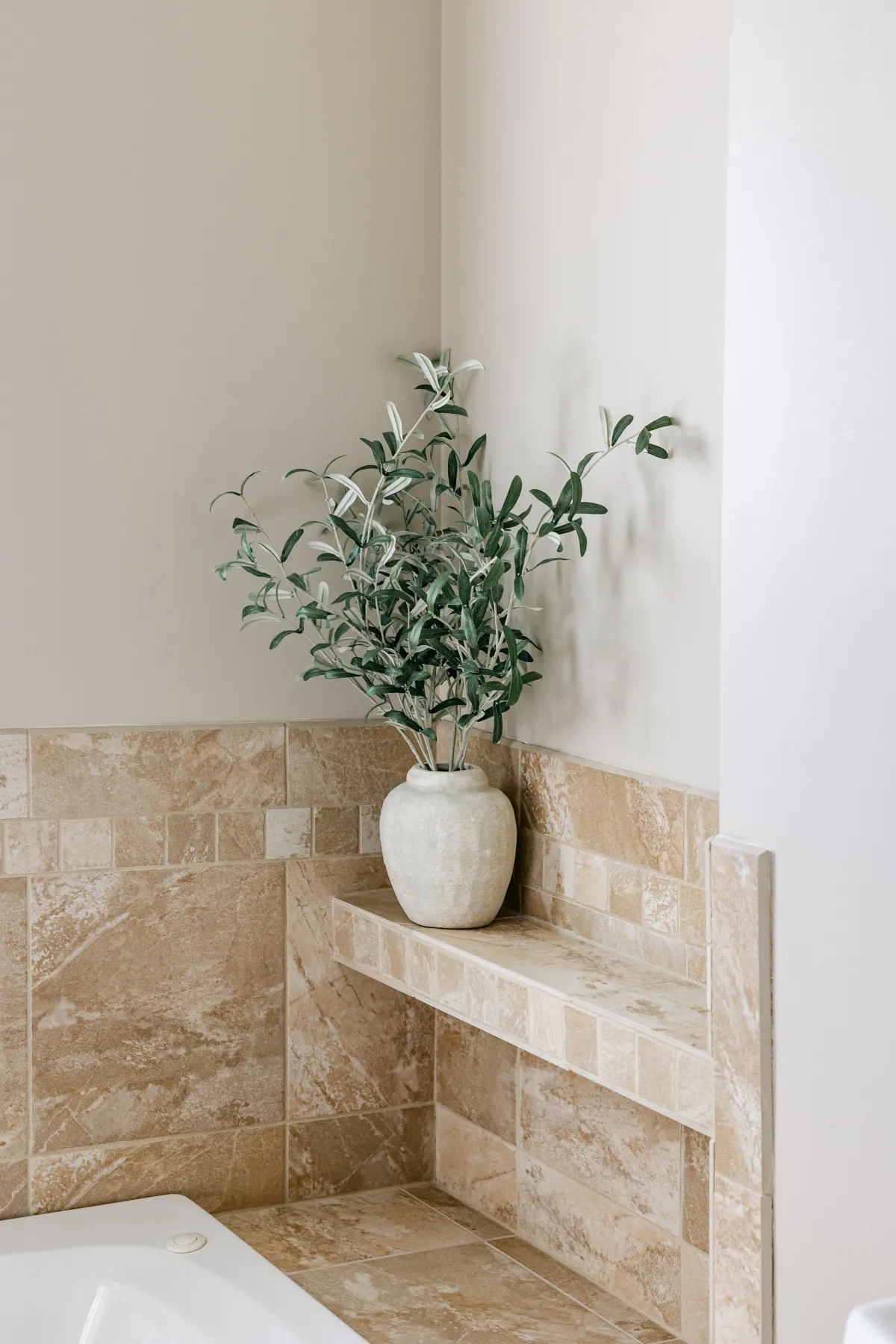 Relaxing elements surround the elegant garden tub, your personal retreat after a long day