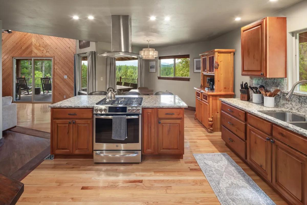 Bright, open kitchen with mountain views, premium appliances, and everything needed to cook for a crowd. Steps from the living area, it’s the perfect gathering space for unforgettable Montana adventures near Glacier National Park.