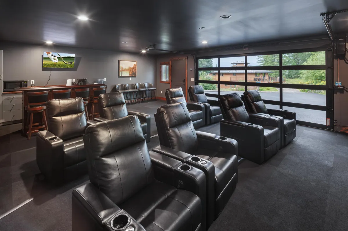 Dedicated media room with plush recliners and large screen for an at-home theater experience. Perfect for movie nights or game-day viewing during your Montana getaway near Glacier National Park.