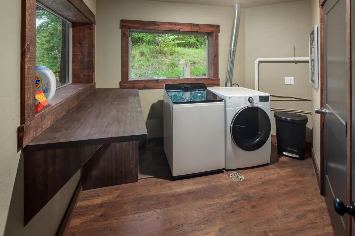 Spacious laundry room with washer, dryer, folding counter, and detergent provided. Perfect for extended stays in this 6BR/5BA luxury Montana vacation rental near Glacier National Park.