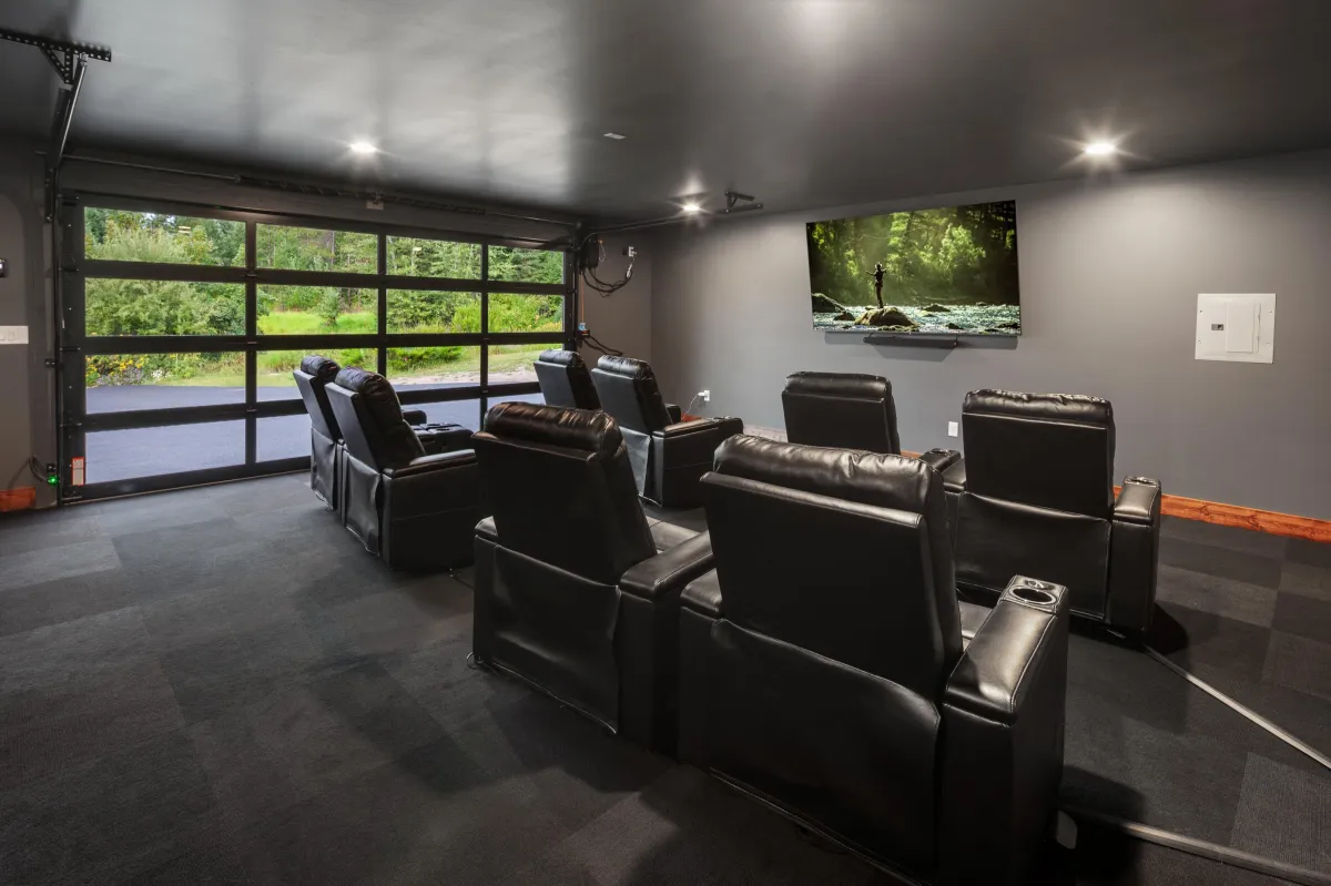 Private media room with plush recliners and large screen for an at-home theater experience. Perfect for movie nights or game-day viewing during your Montana vacation near Glacier National Park.