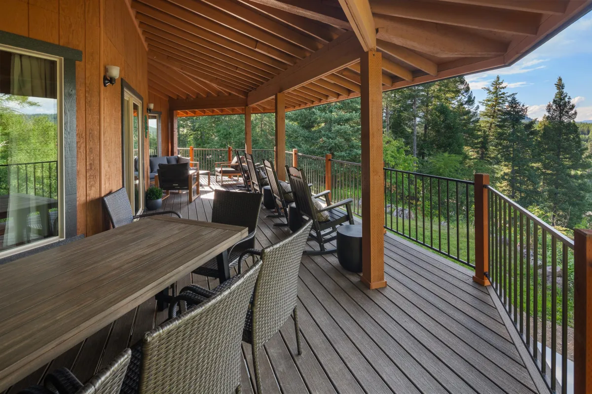Just beyond the front entrance and grill area, the wraparound covered deck at Glacier Gateway Lodge offers ample seating for dining and lounging, including inviting rocking chairs. Overlooking a peaceful wooded lot with sweeping views of the Flathead River and surrounding mountains, it’s the perfect spot to relax and take in Montana’s beauty.