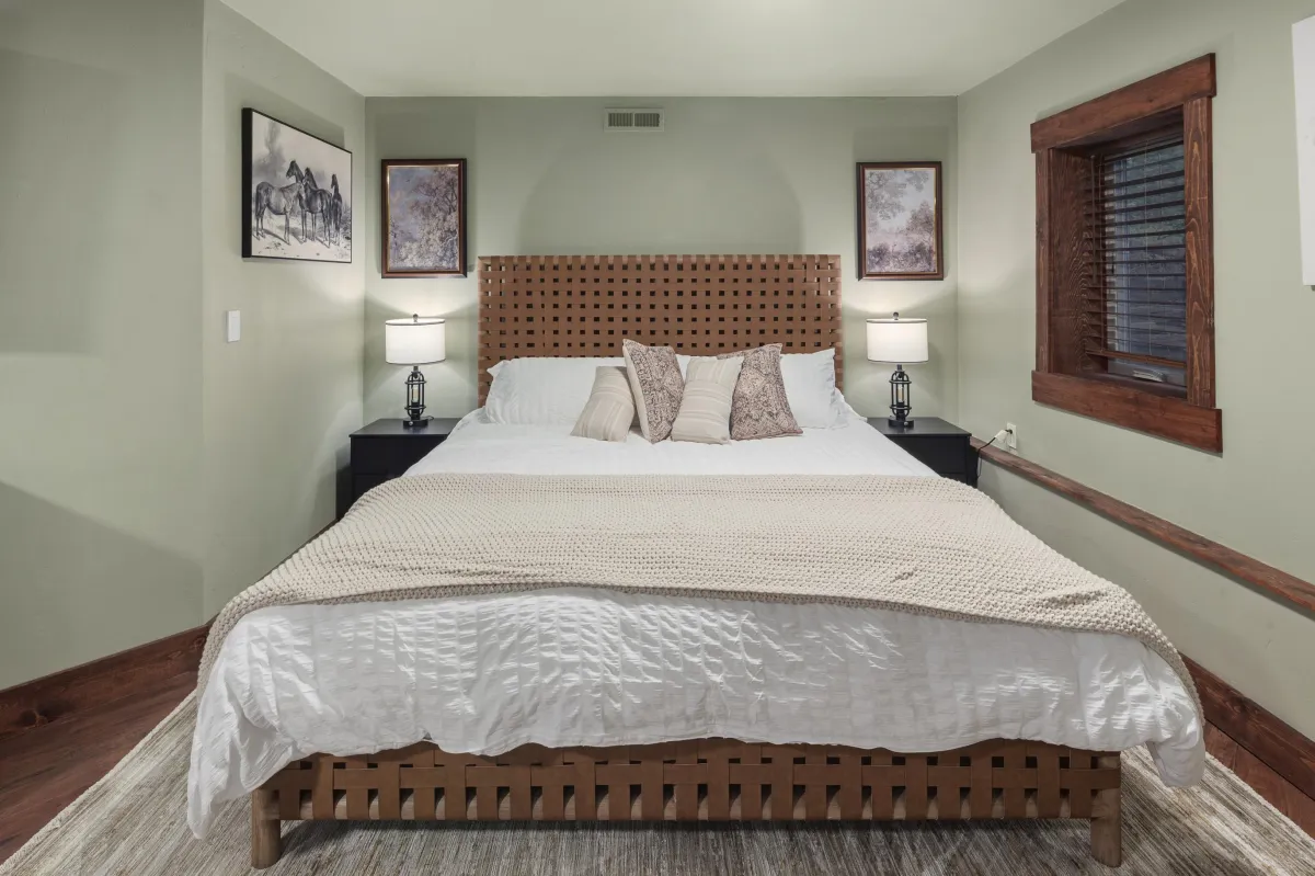 The Eastwood bedroom, a themed king bedroom with seating area and Western-inspired art. A comfortable, stylish retreat in this Montana lodge near Glacier National Park.