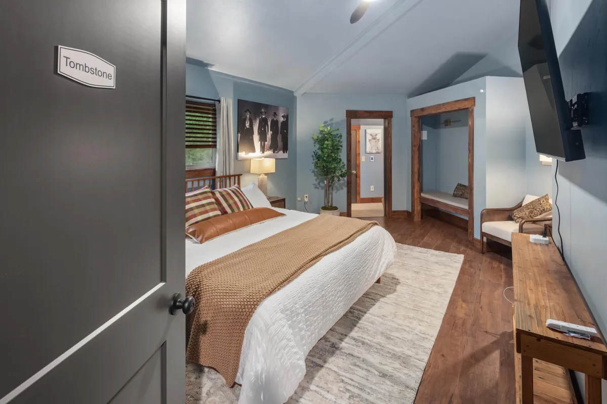 Spacious themed bedroom with plush king bed, warm Western-inspired accents, and cozy seating. A relaxing retreat after exploring Glacier National Park or enjoying Montana’s great outdoors.