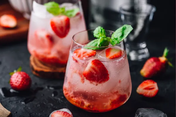 Two gin cocktails with strawberries