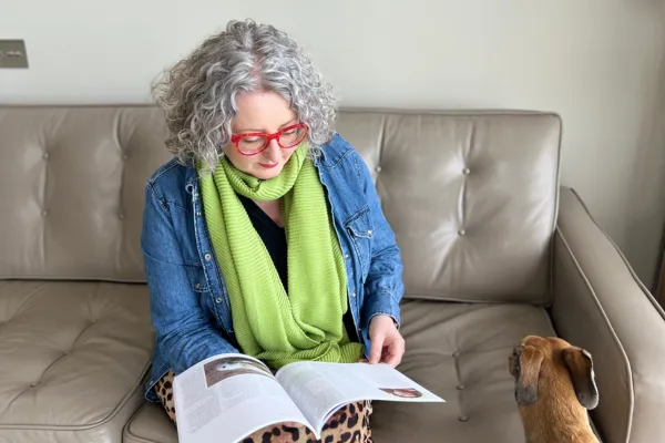 Suzanne Ulph, founder of The Curious wolf, sitting reading a magazine