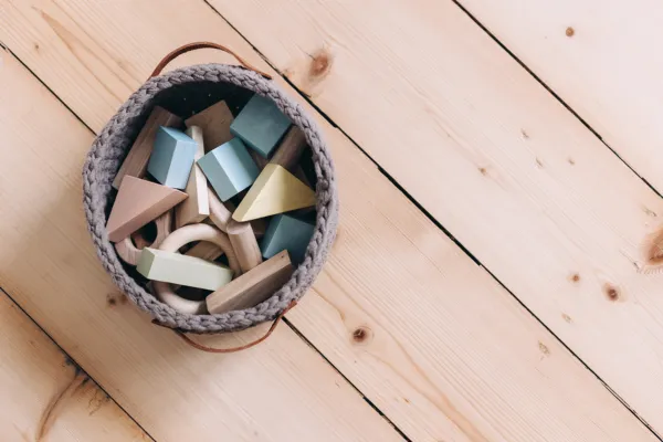 Organized toy bin on wood floor