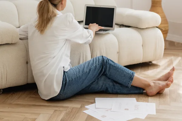 Woman sitting on floor planning her year on computer