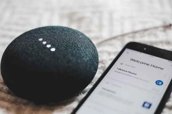 Charcoal google home mini and smartphone