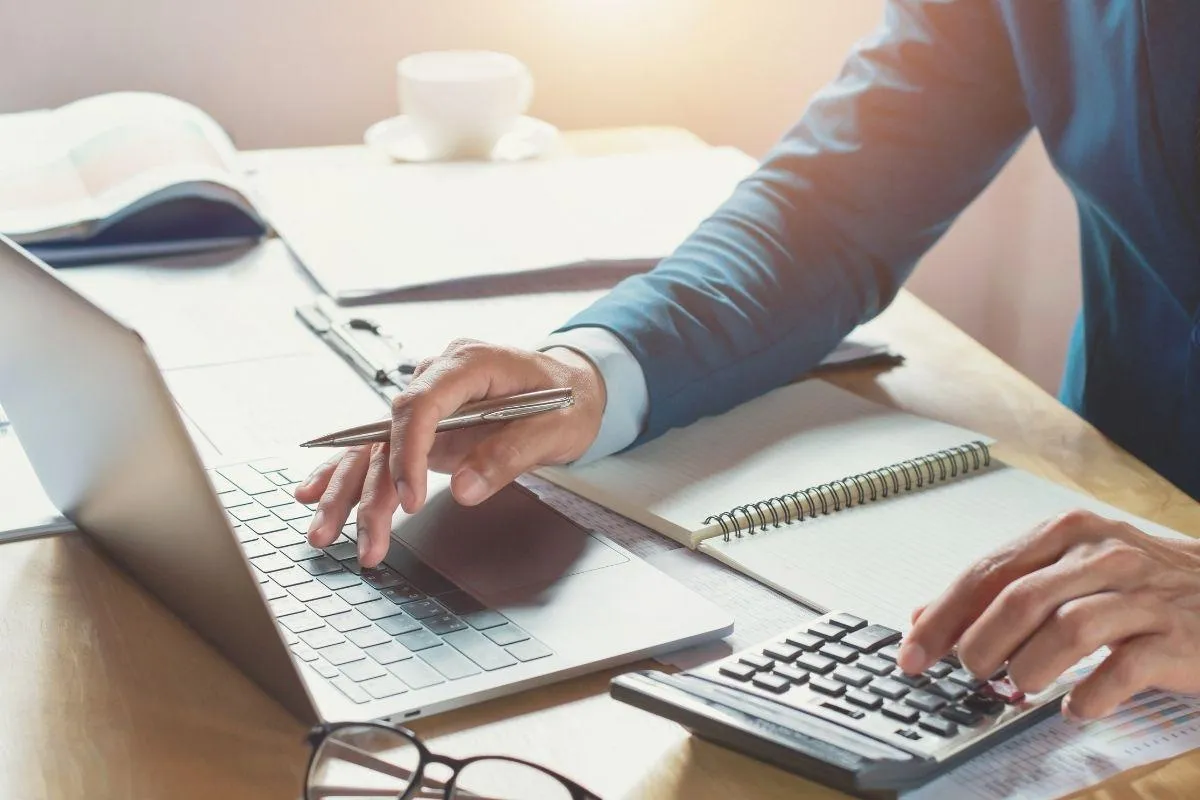 Bookkeeping for tax preparation with person, computer, and documents