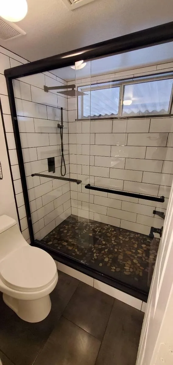 Double sink vanity with LED backlit mirrors and quartz countertop.
