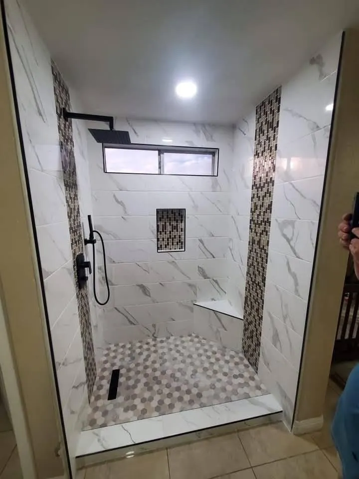 Subway-tiled bathroom with black fixtures and custom vanity.