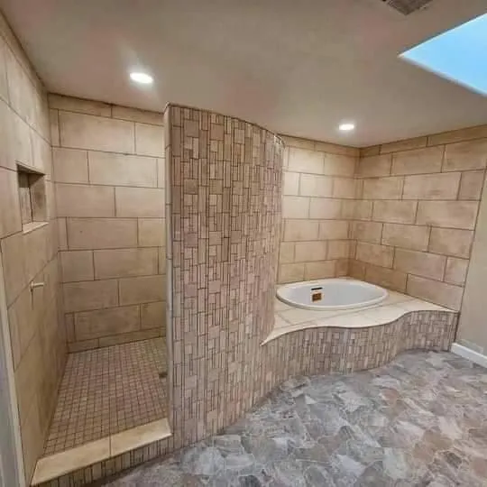 Walk-in rainfall shower with marble tile and floating vanity.