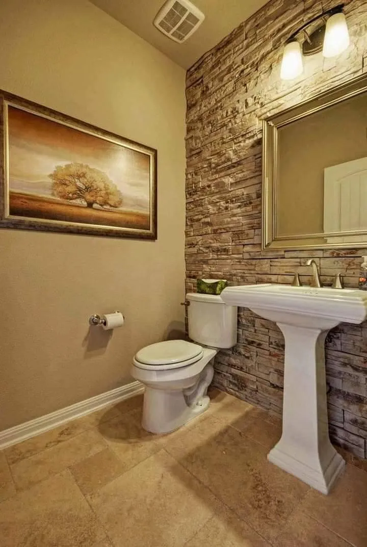 Freestanding soaking tub with floor-mounted faucet and designer tile wall.