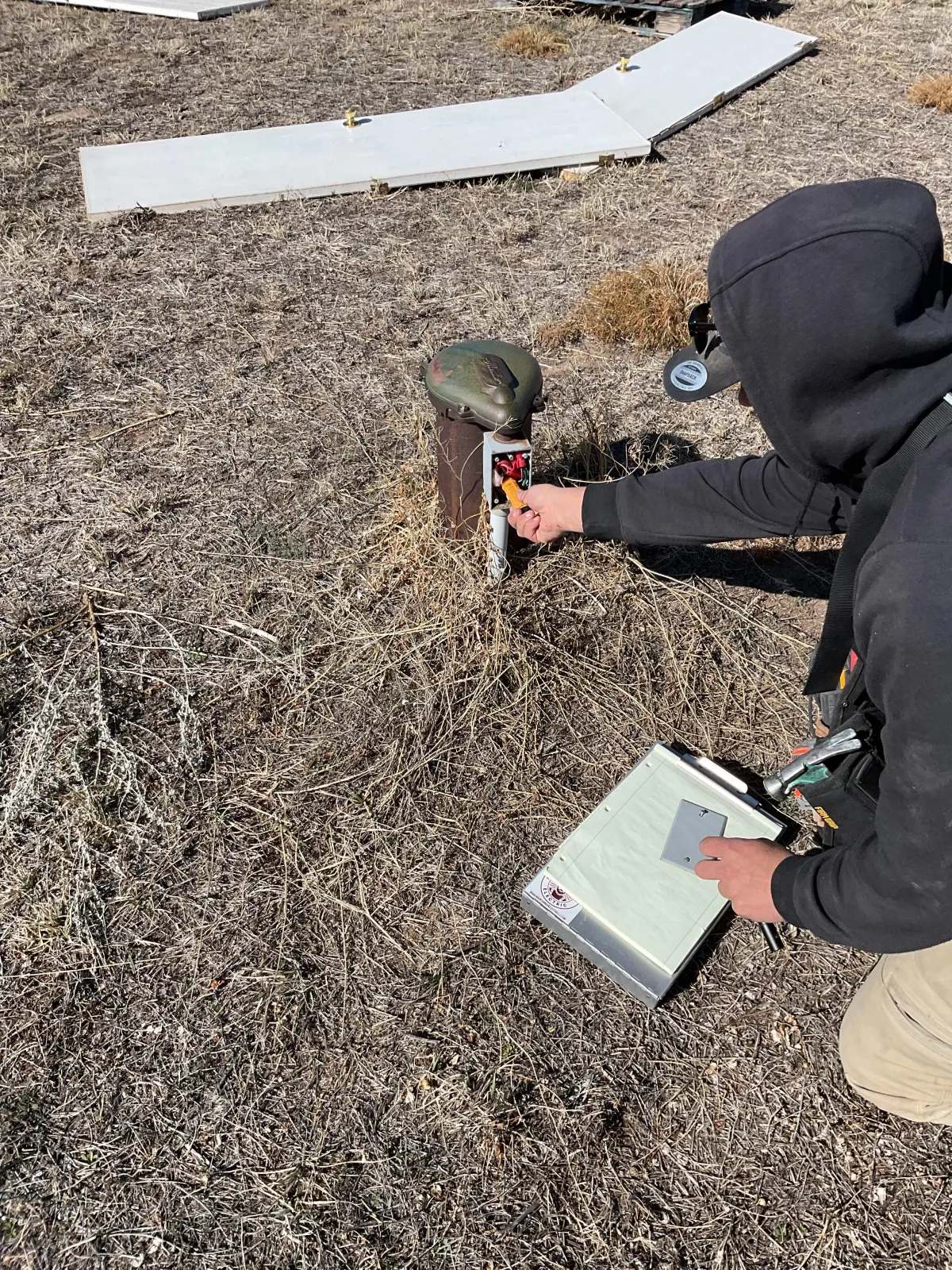 Mountain Man Electric technician inspecting and testing outdoor electrical components at a residential property in Denver.