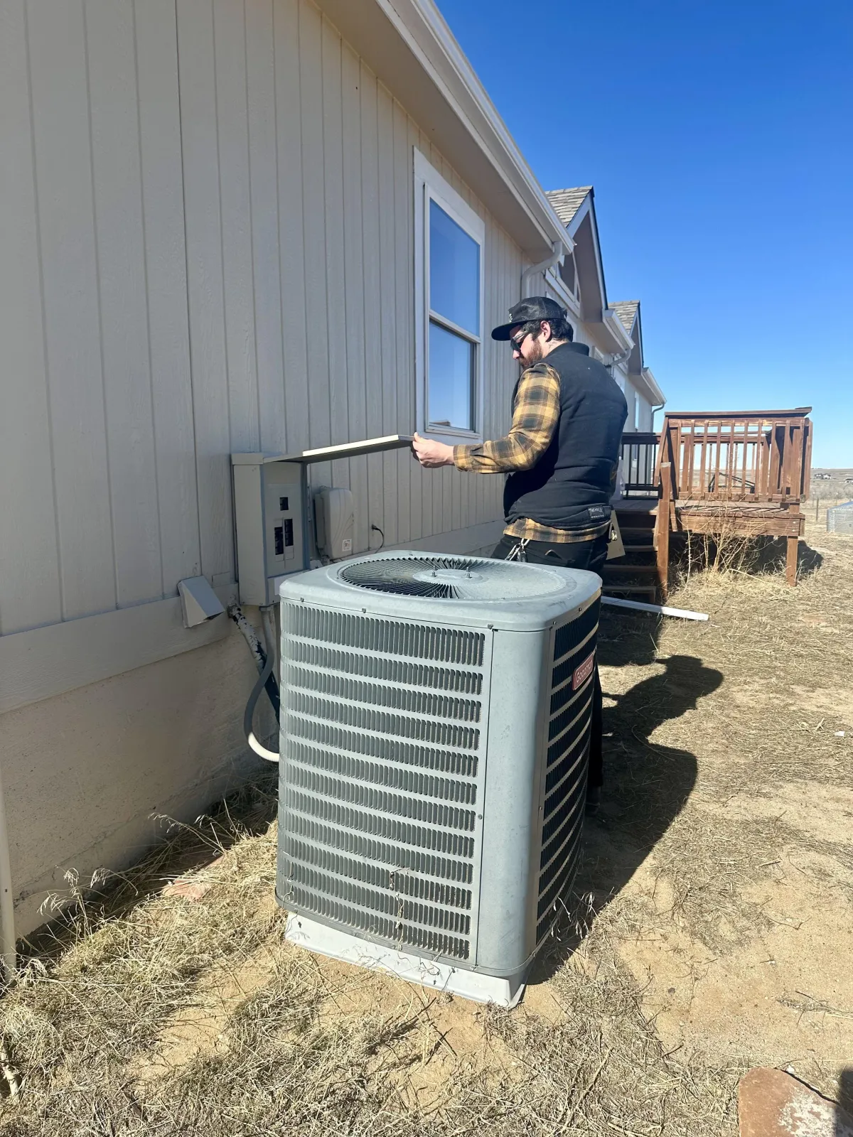 Mountain Man Electric electrician working on electrical connections outside a home in Aurora, Colorado