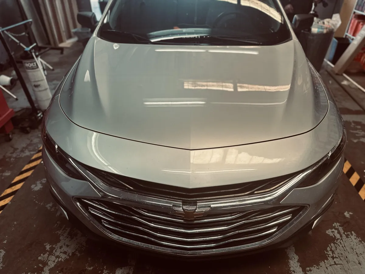 “Close-up of a 2020 Chevy Malibu with a cracked front windshield before replacement.”
