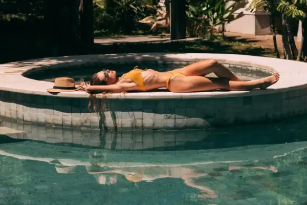 A woman tanning on a pool