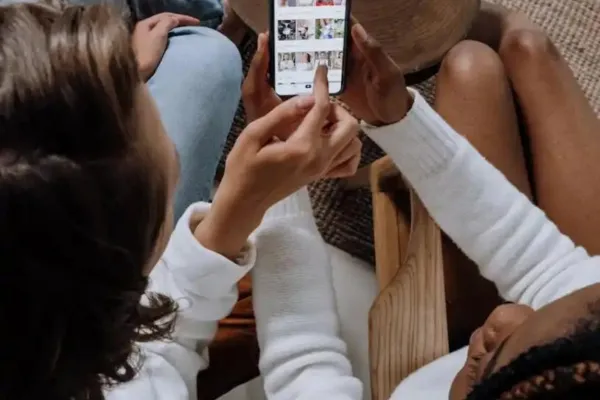 Two women looking at social media on a phone