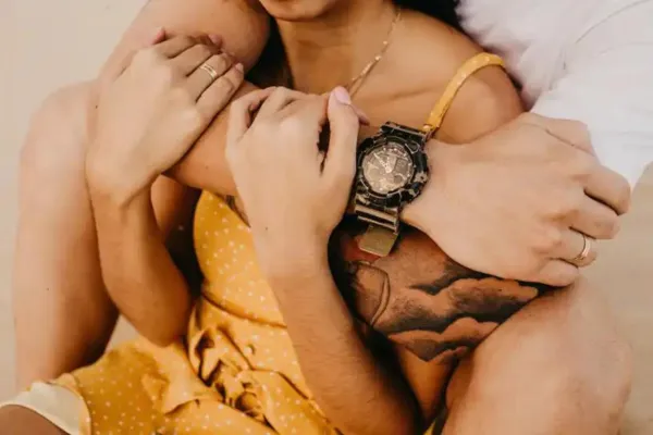 A man with his arms wrapped around a woman
