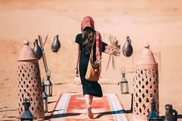 A woman walking on a carpet in a desert