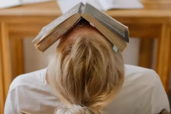 A woman with a book on her head