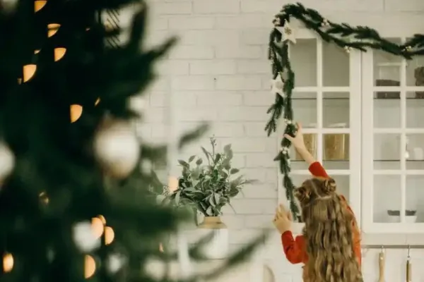 A child hanging Christmas decorations