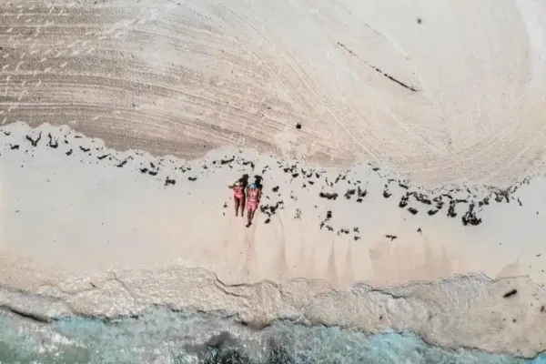 Two women lying on a beach in the Bahamas