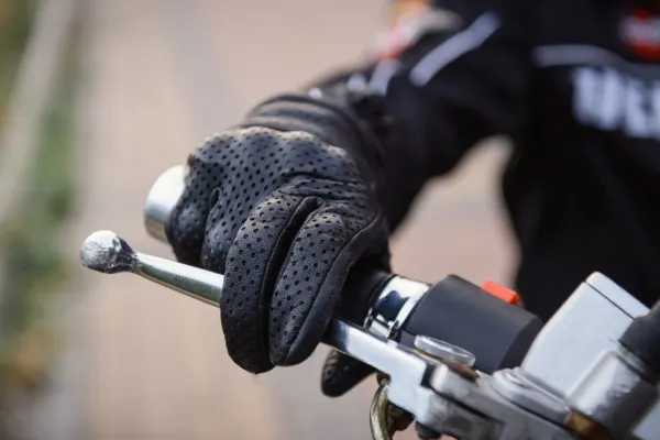 Biker adjusting gloves before hitting the open road.