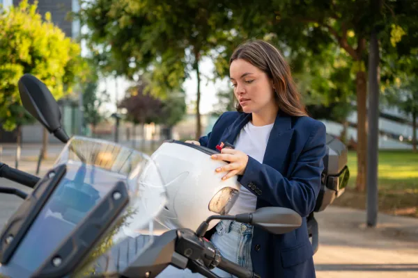 Rider putting on a helmet before a ride.