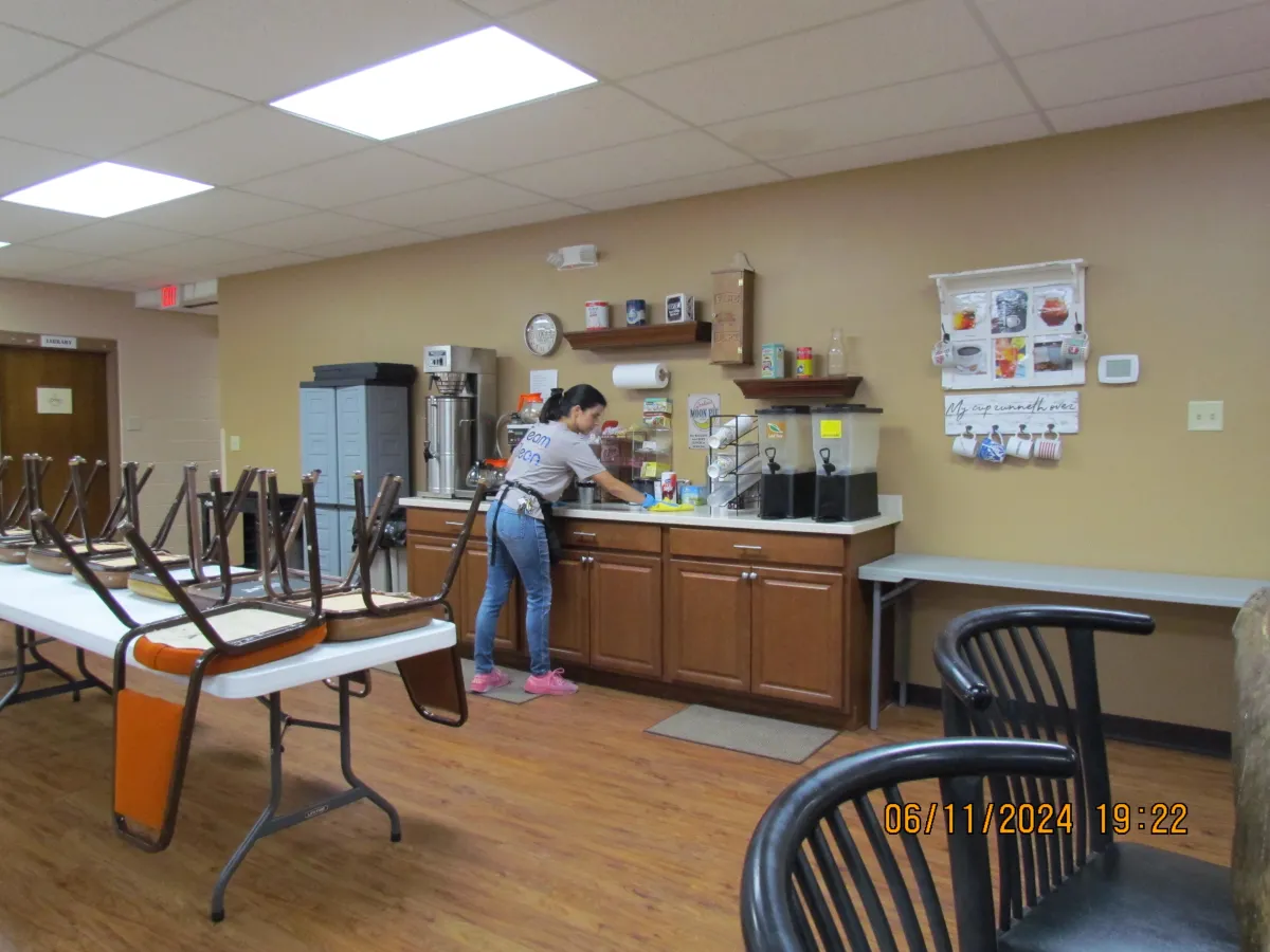 A3D Services employee wiping a counter at one of the church facilities we maintain — showcasing integrity, care, and holistic cleaning for community spaces.