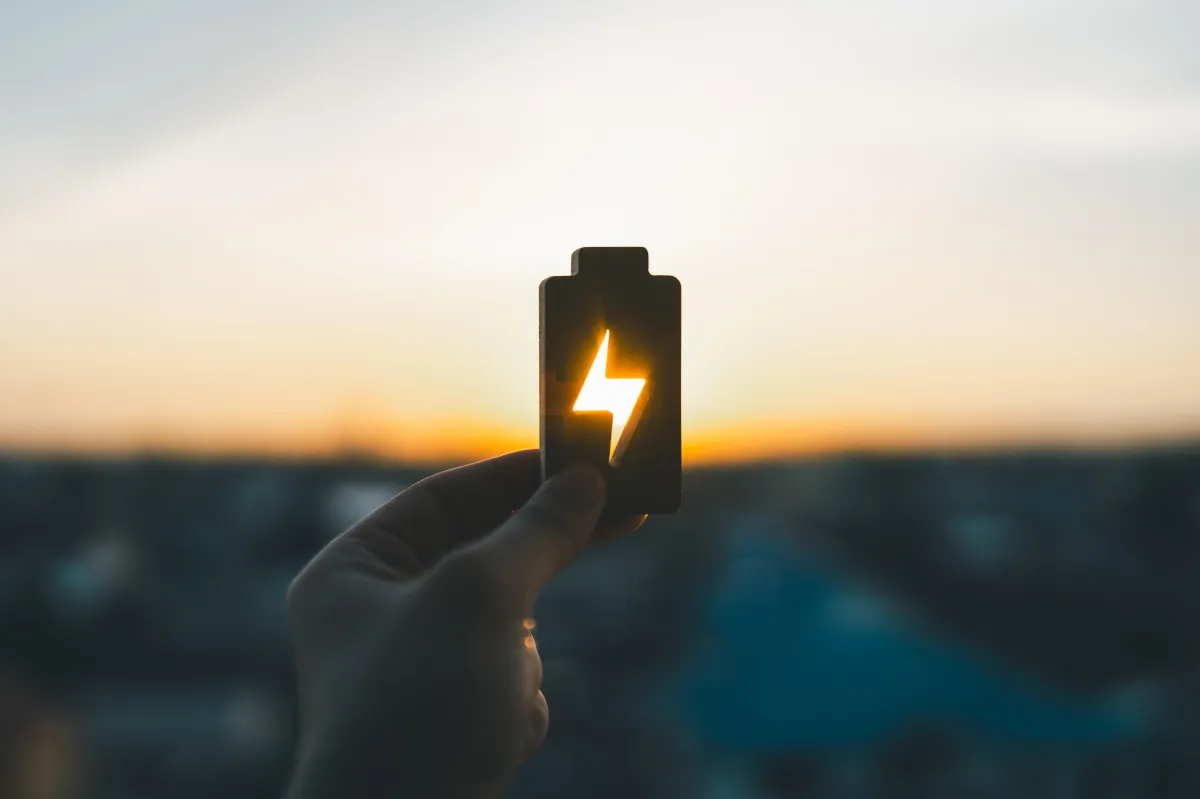 a solar battery lifted in the air by a hand