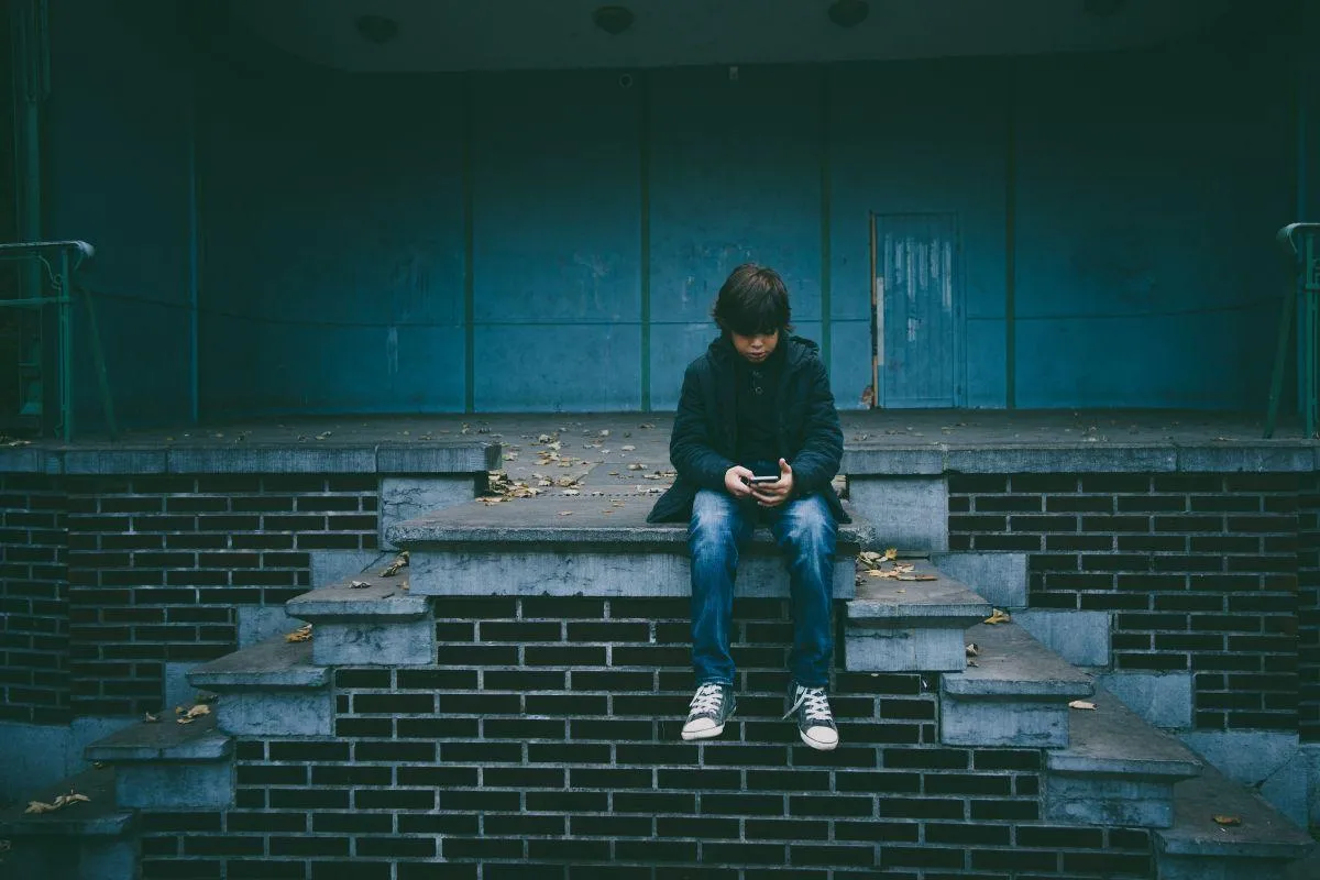 Young adult sitting alone